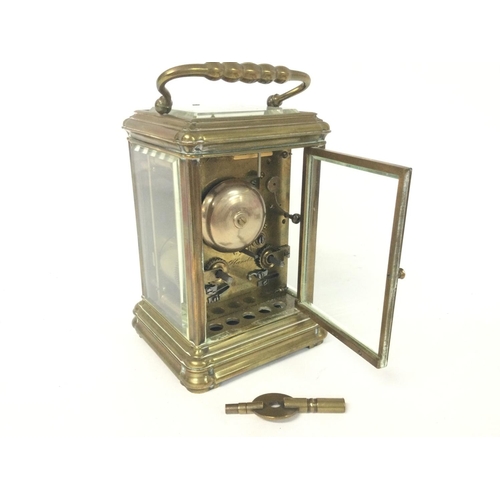 873 - A brass strike repeating carriage clock, with key. Approximately 9x8x16cm. (B)