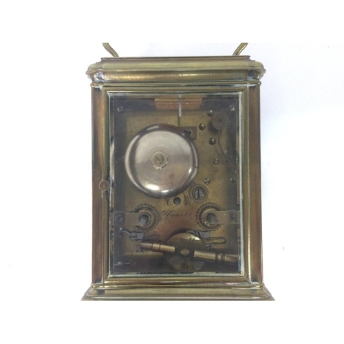 873 - A brass strike repeating carriage clock, with key. Approximately 9x8x16cm. (B)