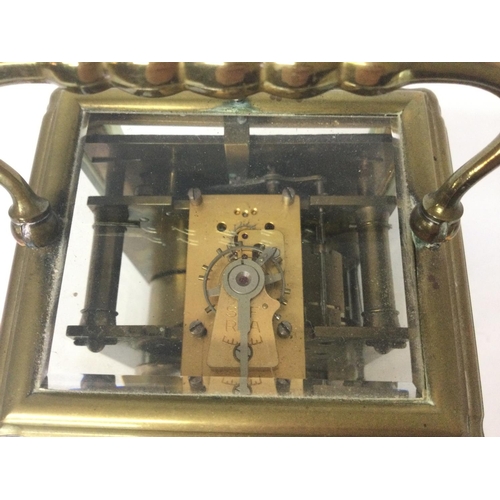 873 - A brass strike repeating carriage clock, with key. Approximately 9x8x16cm. (B)