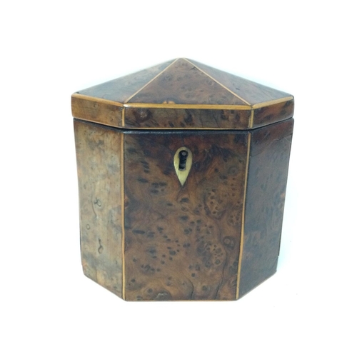 874 - A George III burr yew-wood Tea Caddy of octagonal form with a hinge lid and boxwood lines, with key.... 