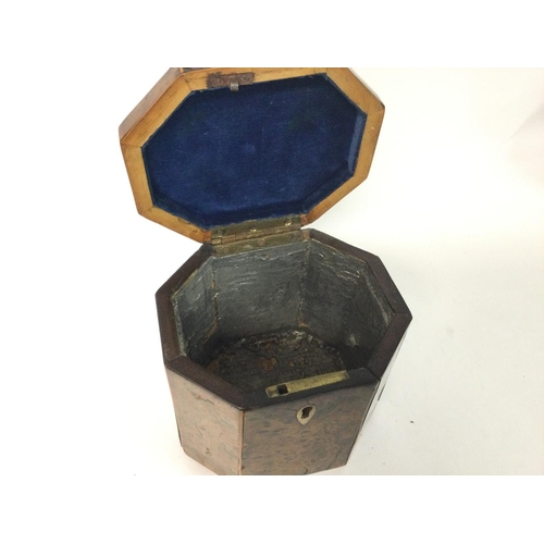 874 - A George III burr yew-wood Tea Caddy of octagonal form with a hinge lid and boxwood lines, with key.... 