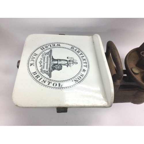 887 - A vintage set of grocer's scales, various weights and a Victorian iron. Shipping category D.