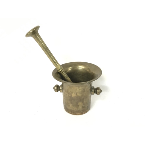 890 - A 18th century brass mortar and pestle.