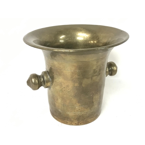 890 - A 18th century brass mortar and pestle.