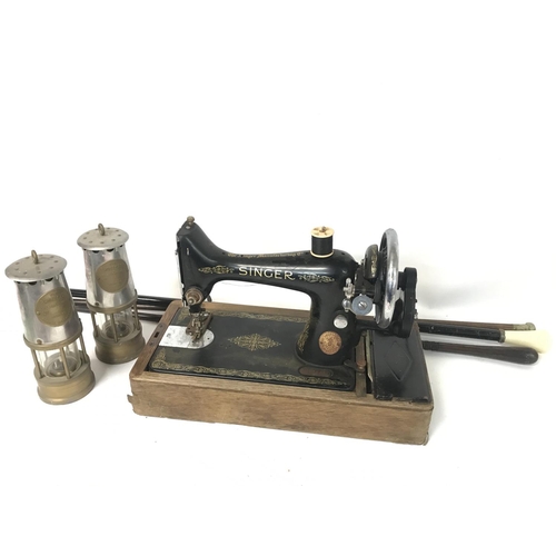 893 - A singer vintage sewing machine, a pair of Protector miners lamps and vintage walking sticks