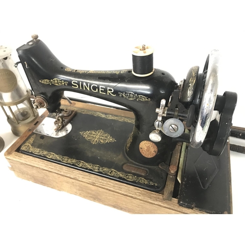 893 - A singer vintage sewing machine, a pair of Protector miners lamps and vintage walking sticks