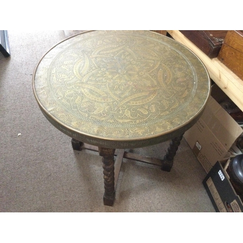 906 - Brass rounded table with a folding stand, 60cm in diameter. (D)