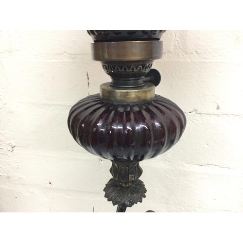 911 - Bronze cherub oil lamp lamp signed Sacha Pan with a ruby red glass reservoir and a ruby glass shade.... 