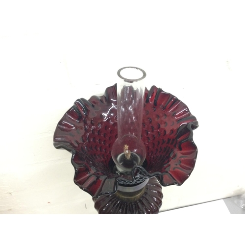 911 - Bronze cherub oil lamp lamp signed Sacha Pan with a ruby red glass reservoir and a ruby glass shade.... 