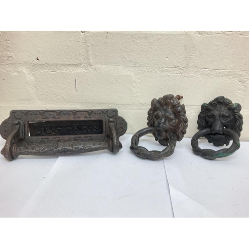 915 - Two 19th century cast iron head door knockers and a Victorian letter box with handle by Kenrick & So... 