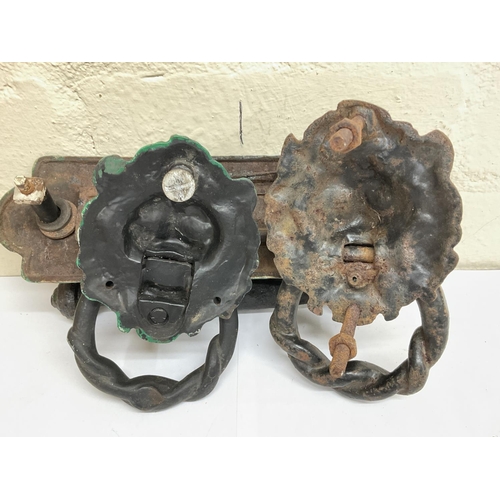 915 - Two 19th century cast iron head door knockers and a Victorian letter box with handle by Kenrick & So... 