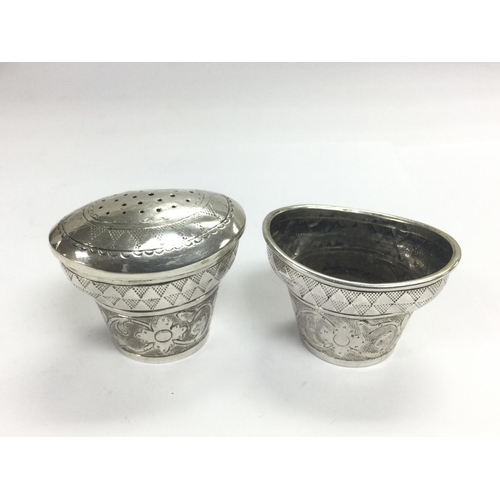 943 - Two silver pepper pots, one lid missing. Shipping category B.