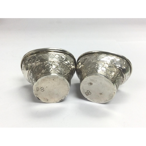 943 - Two silver pepper pots, one lid missing. Shipping category B.