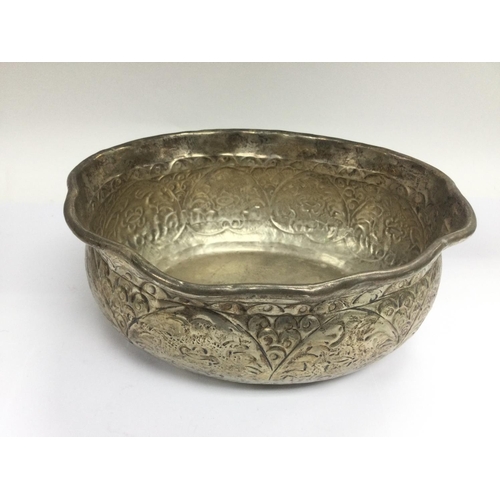 947 - A Burmese silver bowl with repousse work decoration, approx diameter 24cm. Shipping category B.