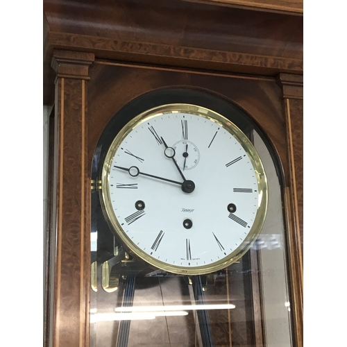 1511 - A Quality German walnut cased regulator wall clock with a visible brass pendulum and two weights. Ma... 