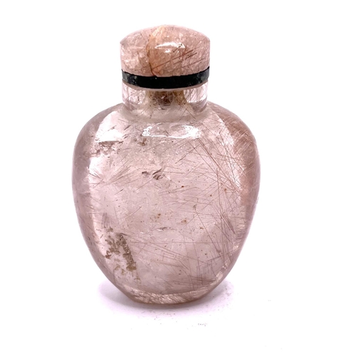 1 - A carved rutile hair Quartz (angel hairs) snuff bottle of ovoid form with matching stopper. 7.2cm. I... 