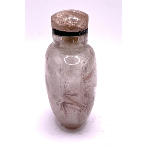 1 - A carved rutile hair Quartz (angel hairs) snuff bottle of ovoid form with matching stopper. 7.2cm. I... 