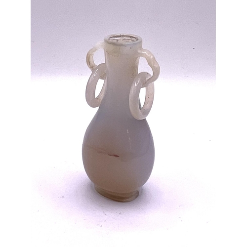 101 - A fine Chinese carved white agate snuff bottle with integral carved rings to shoulders.  7cm