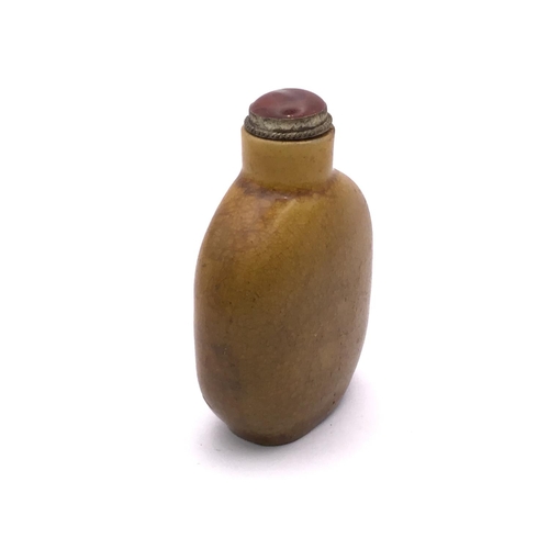 11 - A Chinese yellow crackle glazed snuff bottle with 3 character signature to the base, 6.4cm.