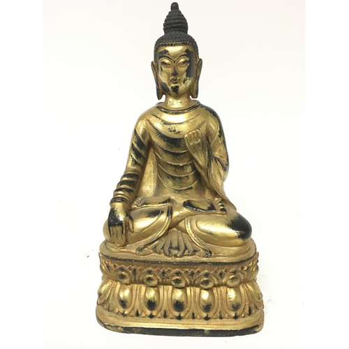 182 - A gilt metal figure of a seated Buddha cast and with an infield base the lower section with a repeat... 