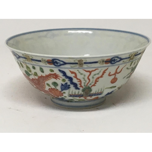 183 - A Chinese Export porcelain bowl the sides decorated with a green and red dragons chasing flaming pea... 