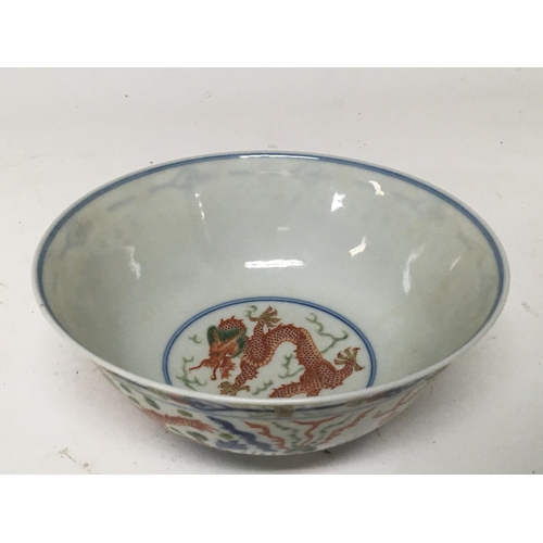 183 - A Chinese Export porcelain bowl the sides decorated with a green and red dragons chasing flaming pea... 