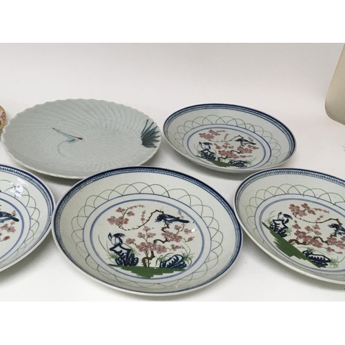 193 - A Japanese dish with impressed pattern a set of six ther dishes decorated in the oriental style and ... 