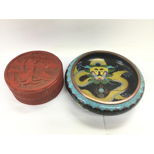 202 - A cinnabar jar and cover and a Cloisonne dish, approx diameter 20cm. Shipping category D.