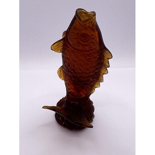 22 - A carved amber glass snuff bottle in the form of a leaping koi, 8.3cm