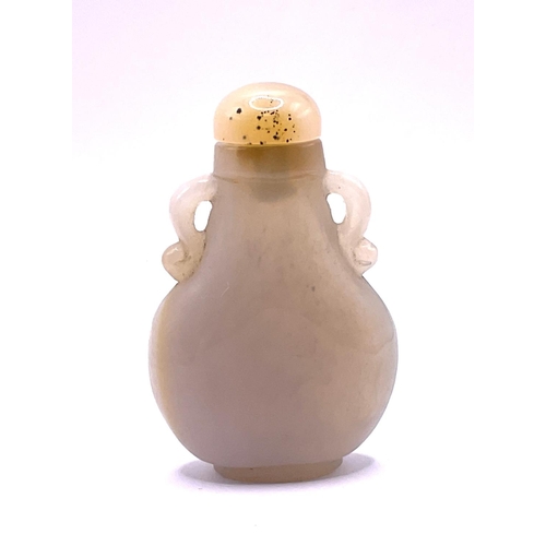 28 - A carved pear shaped white agate snuff bottle with a similar agate stopper. 7cm.