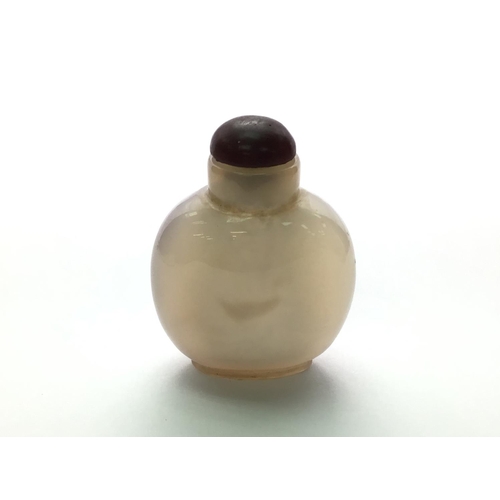 3 - A polished agate bottle with a natural darkened area in the form of a duck. 4.8cm.