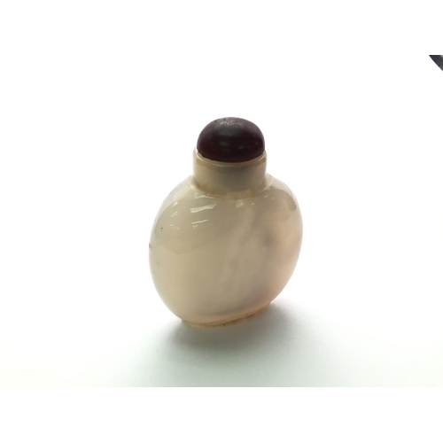 3 - A polished agate bottle with a natural darkened area in the form of a duck. 4.8cm.