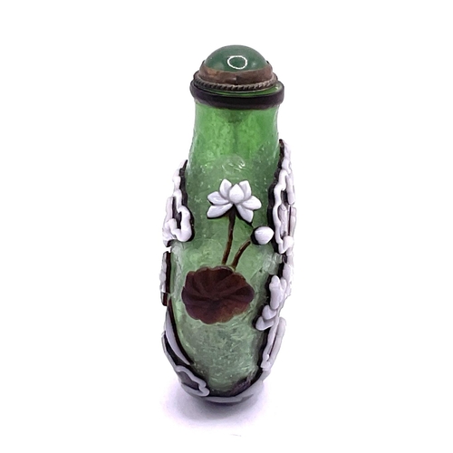 34 - A hand blow 2 layered cameo glass snuff bottle with decoration of lilys. 6.5cm.