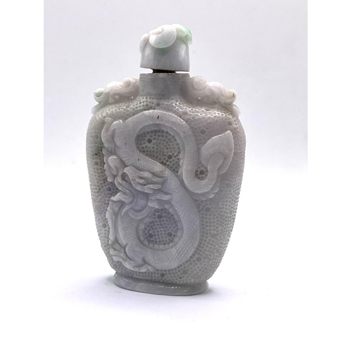 43 - A large apple green and white finely carved jadeite bottle with carved dragon and Buddhist symbol de... 