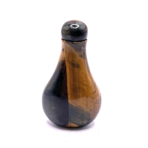 47 - Late 19th century polished Tigers eye stone snuff bottle with exceptional striated colour, of rounde... 