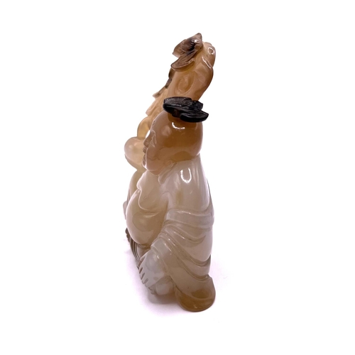 49 - A carved agate hard stone. Snuff bottle in the form of a Buddha, the stopper carved as a bat symbol.... 