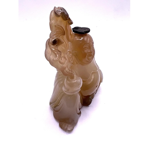 49 - A carved agate hard stone. Snuff bottle in the form of a Buddha, the stopper carved as a bat symbol.... 