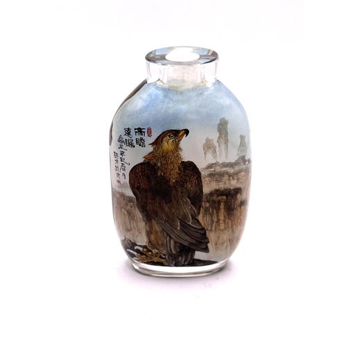 50 - A very finely detailed inside painted snuff bottle, each side with views of an eagle amongst cliff t... 