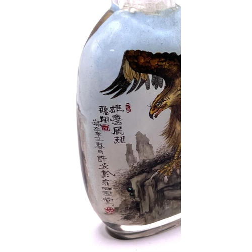 50 - A very finely detailed inside painted snuff bottle, each side with views of an eagle amongst cliff t... 