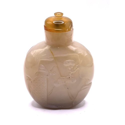 54 - A finely carved hardstone snuff bottle with a carved hunting scene to the front side. 7.5cm.