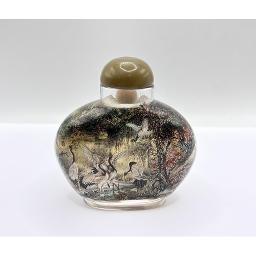 58 - A very finely inside painted table snuff bottle depicting cranes feeding, H.9cm x W.8.5cm. Red signa... 