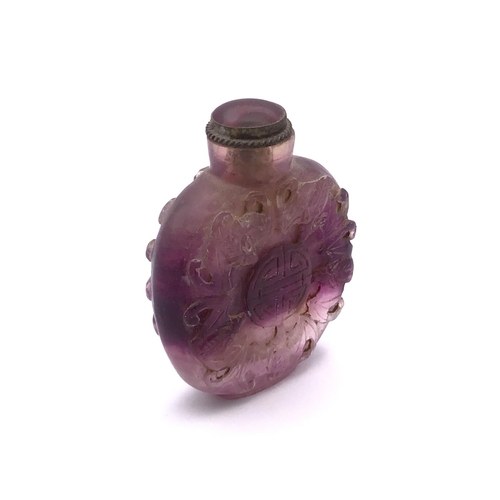 6 - A carved amethyst rock crystal snuff bottle the decoration depicting symbols of five bats which repr... 