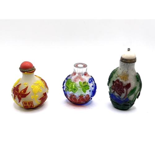 62 - 3 multicoloured cameo glass snuff bottles,  tallest 6cm.