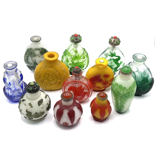 63 - A collection of varied cameo glass snuff bottles. 12 in total smallest 4cm, Tallest 6.5cm