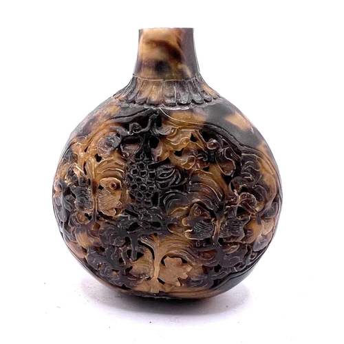 69 - A reticulated carved tortoiseshell snuff bottle, 7cm.