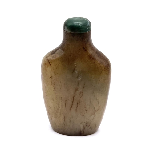 74 - A carved jade snuff bottle with green jade stopper, 6.5cm.