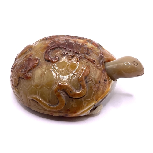 86 - An unusual carved agate pebble in the form of a tortoise, with snake, scorpion, toad, and insect car... 