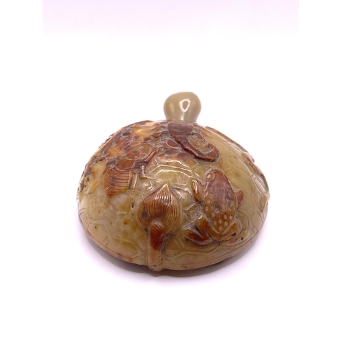 86 - An unusual carved agate pebble in the form of a tortoise, with snake, scorpion, toad, and insect car... 