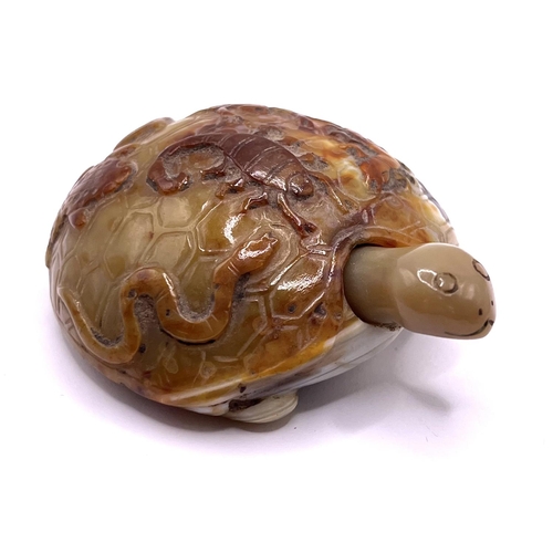 86 - An unusual carved agate pebble in the form of a tortoise, with snake, scorpion, toad, and insect car... 