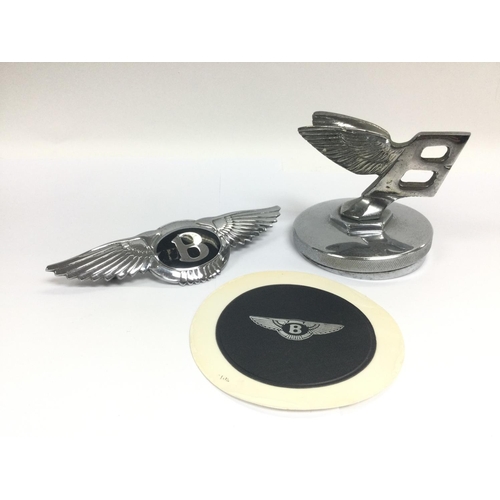 1367 - A Bentley car mascot, badge and tax disc holder with applied Bentley logo (3). Shipping category B.